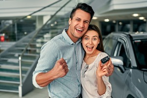Excited couple in the car dealership 